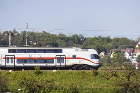 Deutsche Bahn AG InterCity en route, railway embankment and overhead lines, infrastructure,