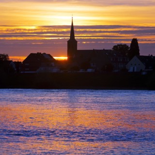 Rhine at sunset with the church of St Dionysius in Volmerswerth, Duesseldorf, Lower Rhine, North