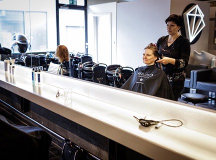 Valentyna Vysotska, hairdresser from Ukraine, combs her customer's hair, taken at the hairdressing
