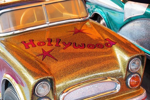 Car in a children's carousel with the inscription Hollywood, glitter and glamour, Spring Festival