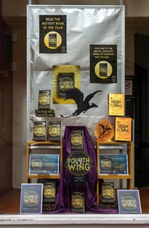 Book display 'Fourth Wing' by Rebecca Yarros in shop window of Waterstones bookshop, Ipswich,