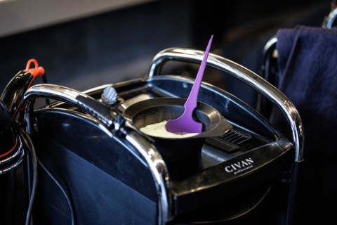 Tray of a hairdresser with mixed hair colour, scissors and comb, taken in the hairdressing salon