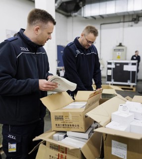 Customs officers check a load of an aircraft that has landed in the cargo area at the airport,