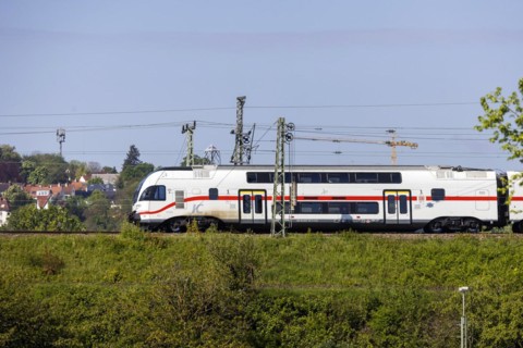 Deutsche Bahn AG InterCity en route, railway embankment and overhead lines, infrastructure,
