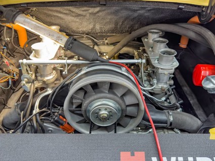 View into engine compartment of vintage historic Porsche 911, front centre fan wheel, right three
