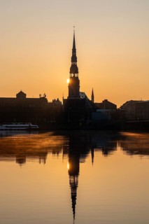 Sunrise on the Daugava River behind St Peter's Church, Riga, Latvia, Europe