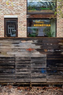 Excavation pit with basketball hoop, behind it a window of a beauty parlour, Riga, Latvia, Europe