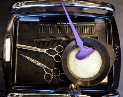 Tray of a hairdresser with mixed hair colour, scissors and comb, taken in the hairdressing salon