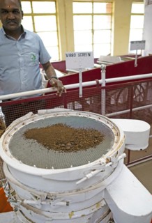 Indian man, 40 years old, showing an automatic tea strainer at the Munnar Tea Museum, Munnar,