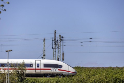 Deutsche Bahn AG InterCityExpress ICE en route, railway embankment and overhead lines,