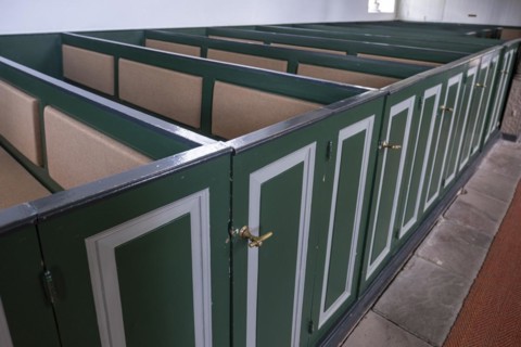 Pews with green doors in the Protestant Reformed Church from 1401 in Greetsiel, Krummhoern, East