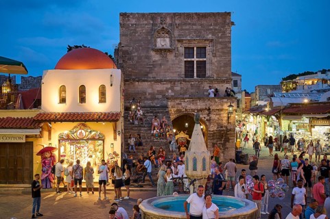 St Paul's Gate, Hippocrates Square, Lively square at night with a fountain and surrounding shops,