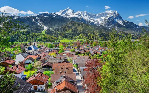 View of the village in spring with the Partenkirchen parish church in front of the Zugspitze group