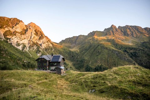 Alpine club hut, Hochweisssteinhaus mountain hut, mountain landscape with green mountain meadows