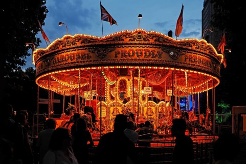 Children's carousel with evening lighting at Queens Walk on the Thames, London, England, Great