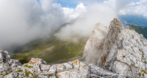 Rocky narrow summit ridge, cloudy mountain peak, summit of the Great Kinigat, Carnic Main Ridge,