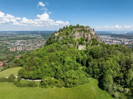 Aerial view of the Hohentwiel volcanic cone with Germany's largest fortress ruins, behind it the