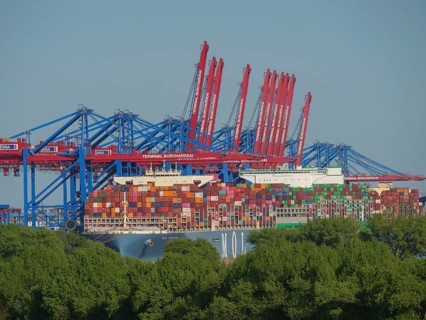 Large container harbour with astonishing amounts of stacked containers and cranes in the