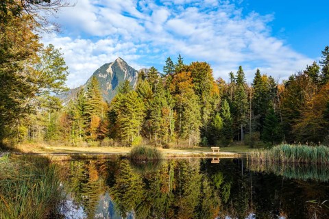 Idyllic view of a lake with reflection surrounded by autumn forest and mountains, Kernwald, Kerns,