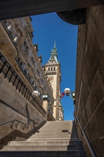 View of Hamburg City Hall through a staircase passage under a blue sky, Hamburg, Germany, Europe