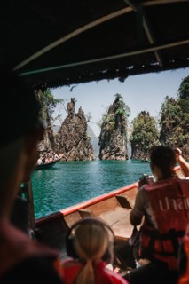 View from a boat of majestic limestone cliffs and clear water. Khao Sok National Park, Thailand,