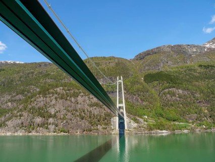Panoramic shots of a bridge leading through a beautiful mountain landscape, bridge in a fjord with