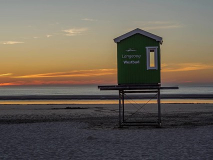 Langeoog Westbad rescue tower on the beach at sunset with a calm sea, beautiful sunset on the beach