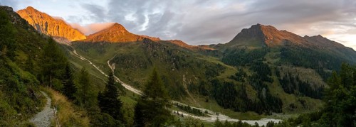 Panorama, rocky mountain peak Porze and green mountain landscape with river valley at sunrise,
