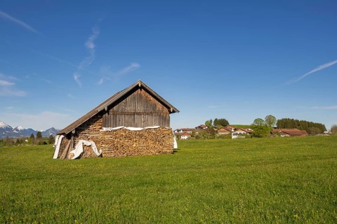 Wooden hut near Fuessen, woodpile, Allgaeu Alps, snow, meadow, Allgaeu, Bavaria, Germany, Europe