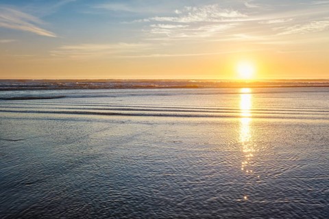 Atlantic ocean sunset with surging waves at Fonte da Telha beach, Costa da Caparica, Portugal,