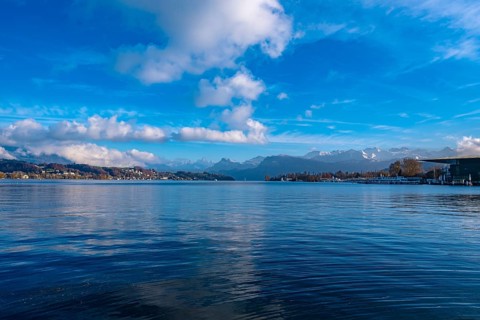 Lake Lucerne with mountain landscape in the background and blue sky with clouds, Lucerne,