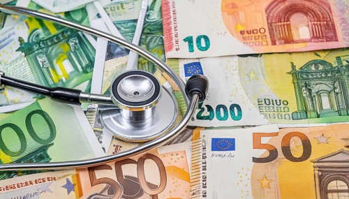 Symbolic photo cost of medicine, a stethoscope and medical instruments on a surface generated from