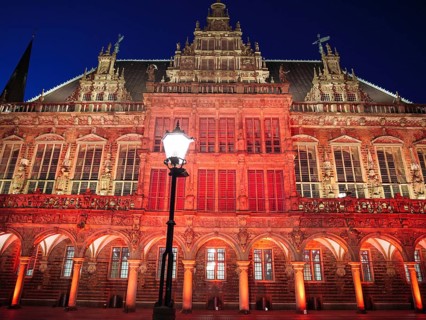 Historic building with richly decorated facade, illuminated in the warm glow of evening lighting