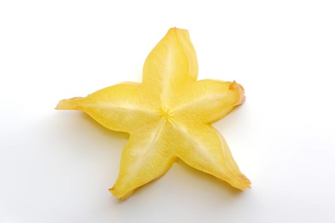 Star fruit or carambola (Averrhoa carambola), sliced fruit on a white background