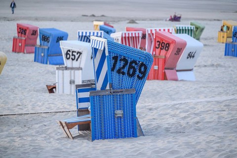 Blue beach with colourful beach chairs, relaxed atmosphere in typical beach holiday ambience, many