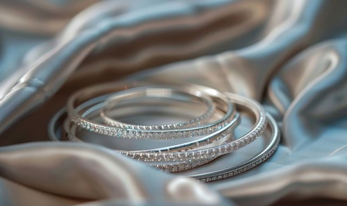 Set of silver bracelets arranged on a satin material background AI generated