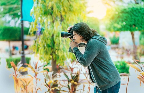 Male photographer taking photos in a public park, Nagarote. Photographer taking photos on the