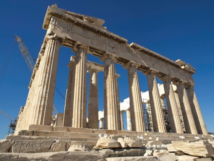 Close-up of the Parthenon with its classical columns under a clear sky, historical columns and