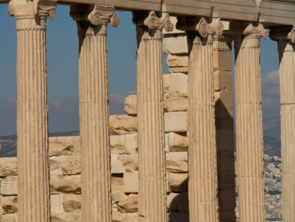 Close-up of ancient marble columns with a clear sky in the background, historical columns and ruins
