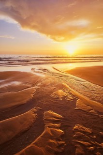 Atlantic ocean sunset with surging waves at Fonte da Telha beach, Costa da Caparica, Portugal,