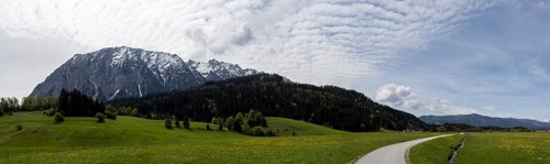 Salzkammergut cycle path leads through a meadow, cloudy mood over the Grimming, panoramic shot,