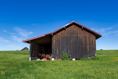 Wooden huts in a meadow near Fuessen, near Buching, Allgaeu, Bavaria, Germany, Europe