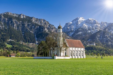 Pilgrimage church of St Coloman in spring, sun, behind Neuschwanstein Castle, Schwangau, Fuessen,
