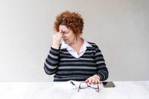 A mid-adult redhead woman stopped working because of a headache