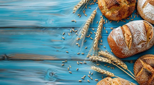 Variety of fresh loaf of bread and wheat on a rustic table with a lot of copy space, AI generated
