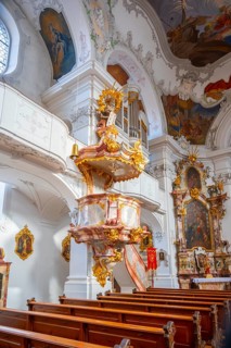 Baroque pulpit with golden decorations, interior view of the Catholic parish church, Minster of Our