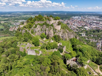 Aerial view of the Hohentwiel volcanic cone with Germany's largest fortress ruins, behind it the