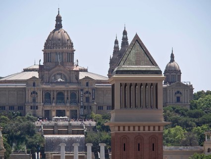 Close-up of a historic building with a magnificent dome and detailed tower against the background