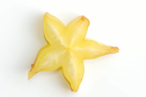 Star fruit or carambola (Averrhoa carambola), sliced fruit on a white background