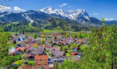 View of the village in spring with the Partenkirchen parish church in front of the Zugspitze group